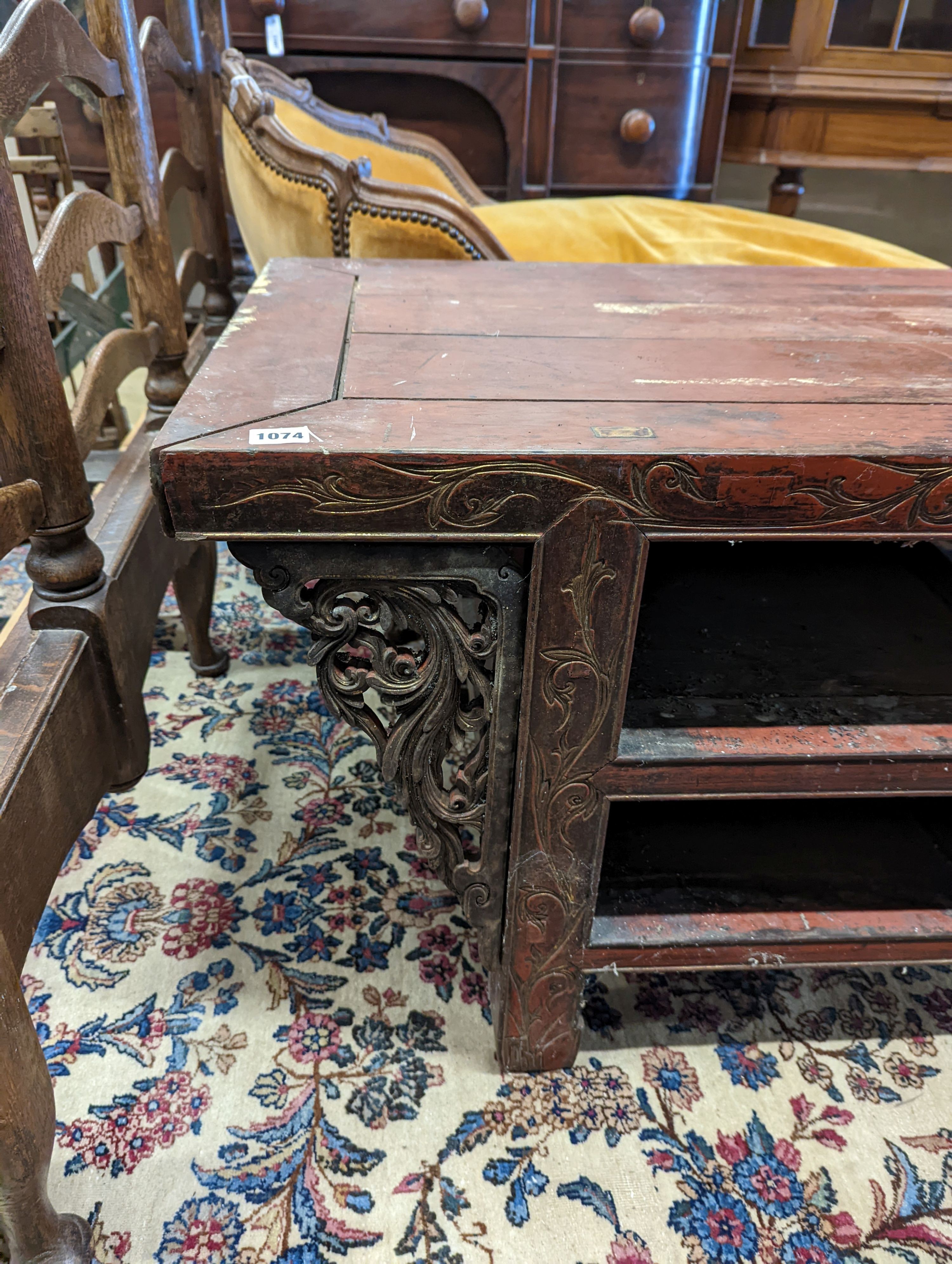 A Chinese red lacquer hardwood low altar table, width 240cm depth 56cm height 56cm